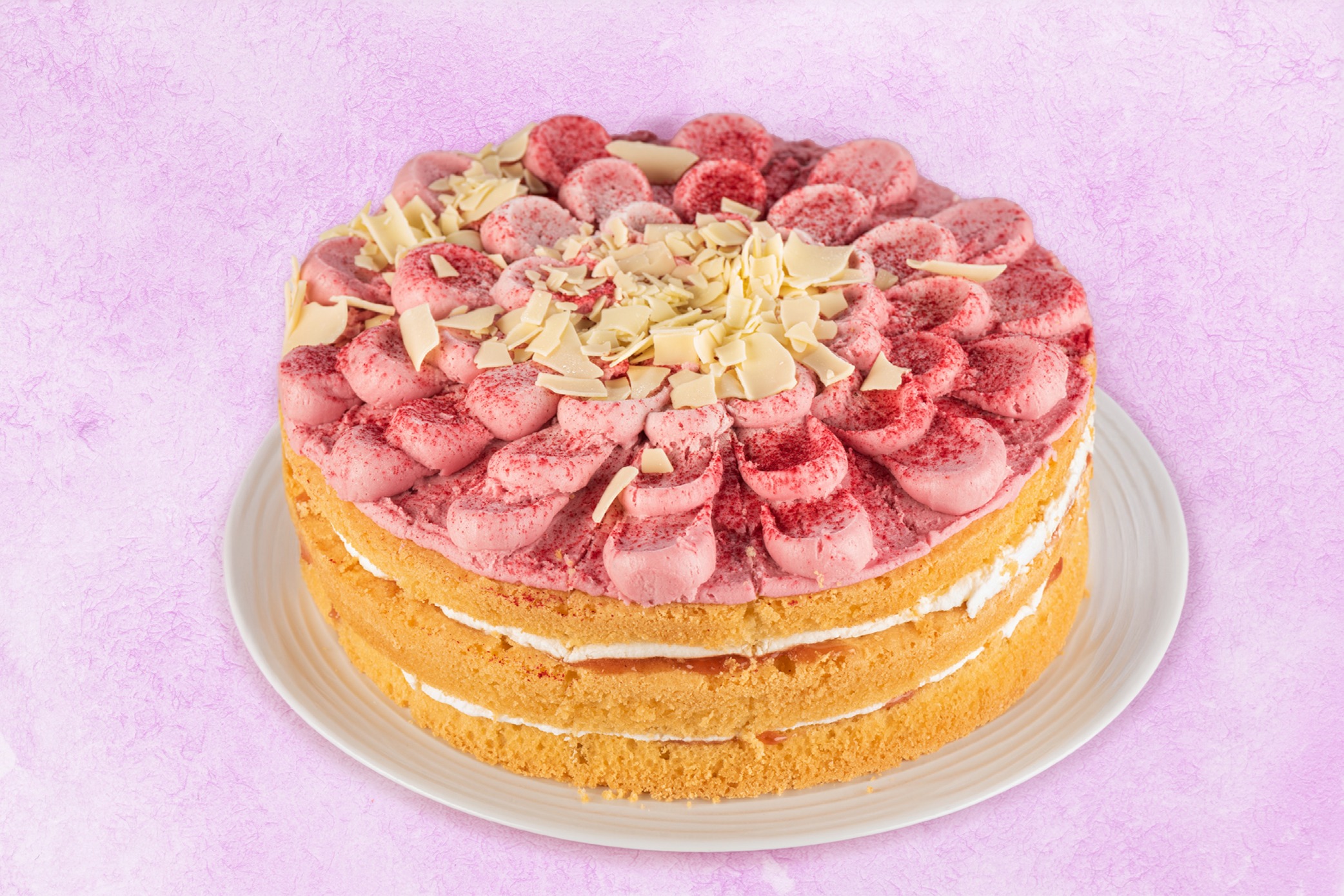 GF-Raspeberry-white-chocolate Layered raspberry sponge cake with pink buttercream