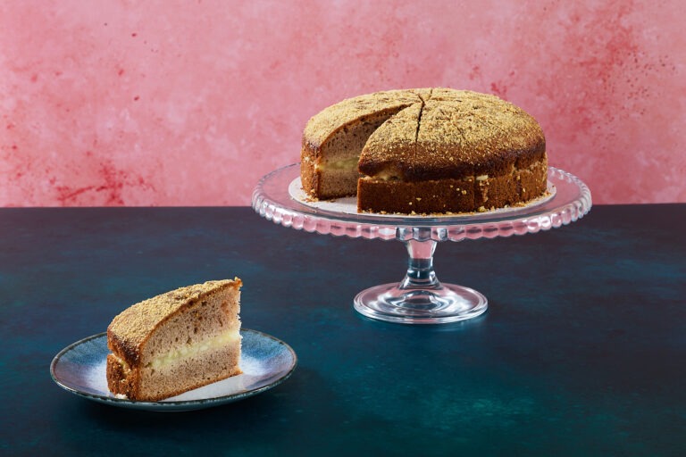 Salted caramel and apple cake with caramel frosting and apple slices.